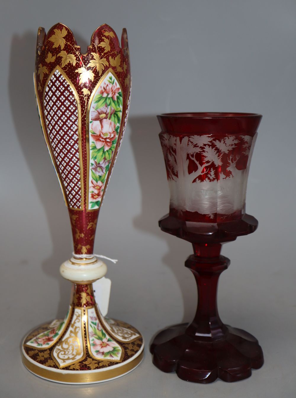 A Bohemian etched ruby glass goblet, together with a gilded cranberry glass vase, tallest 29cm